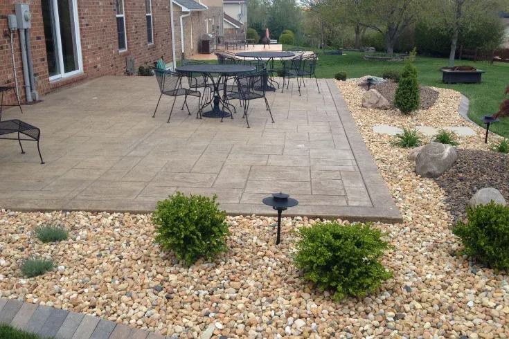 rock border concrete flooring for patio
